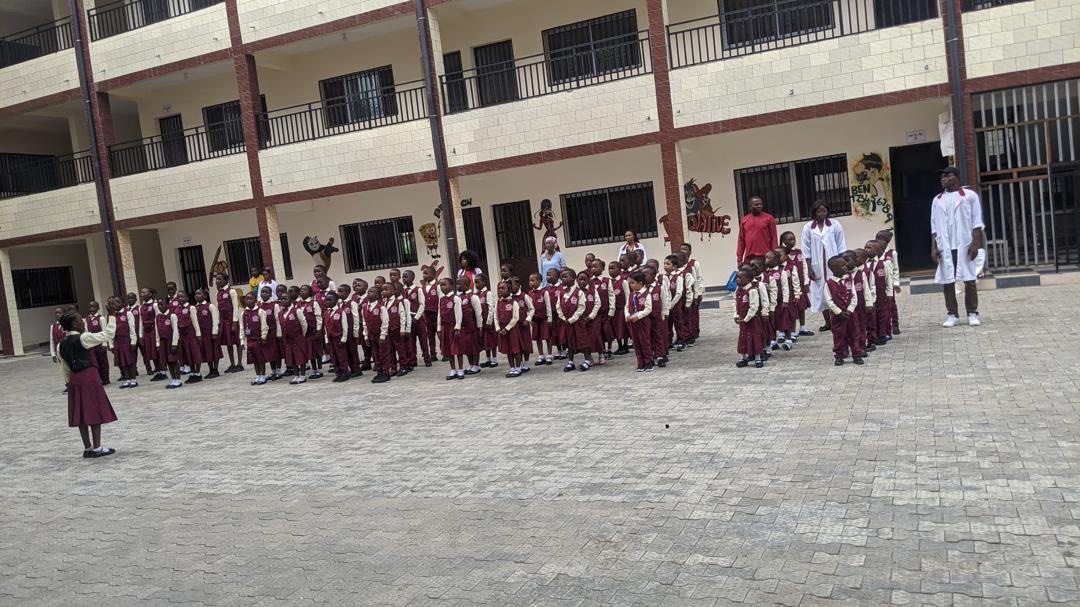Pupils assembled in the school courtyard in front of the building