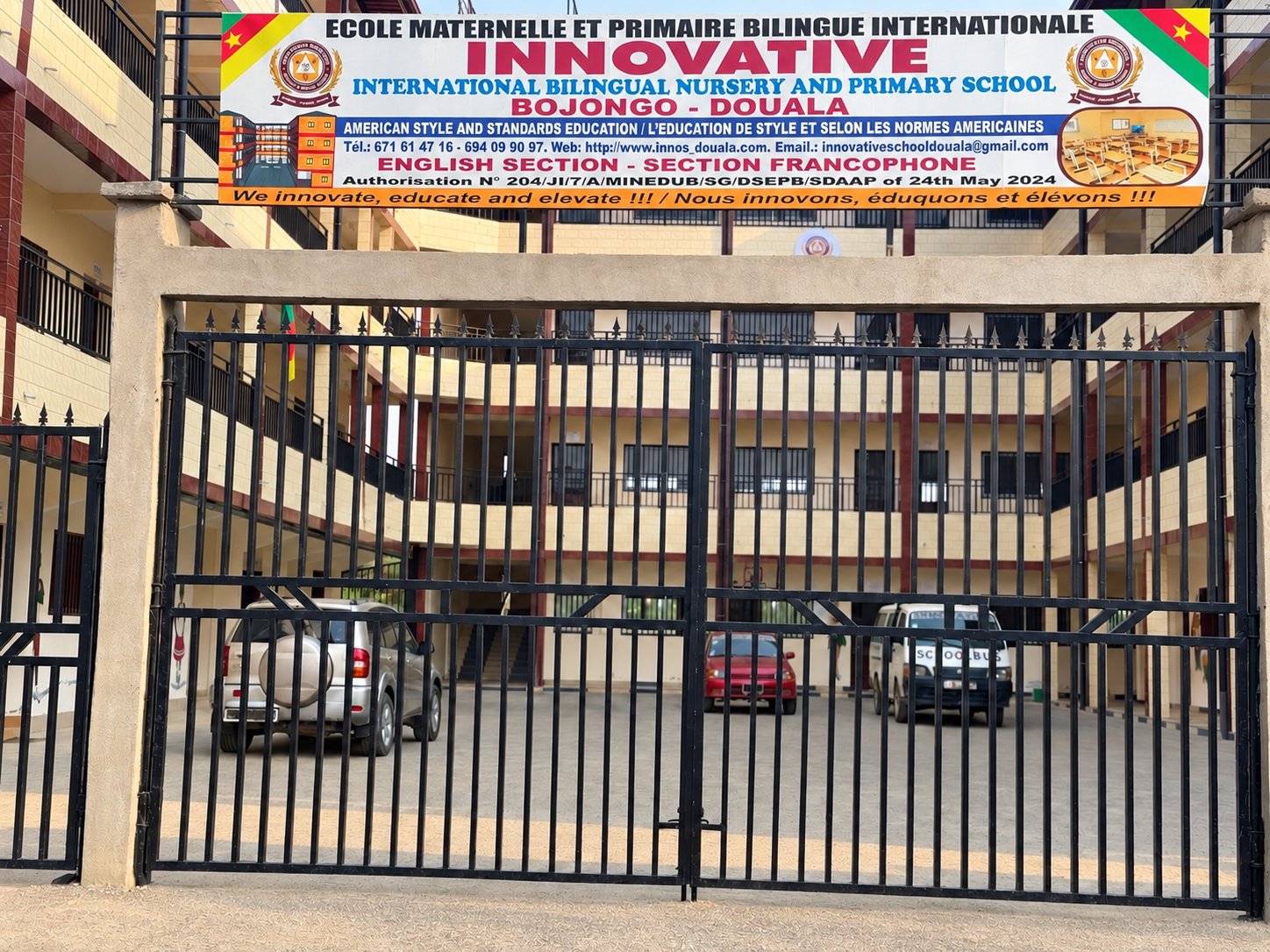The school signboard above the front entrance gate