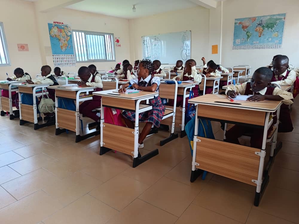 Pupils writing at their desks in an Innovative classroom
