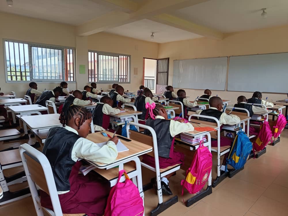 A view across a classroom as pupils work at their desks