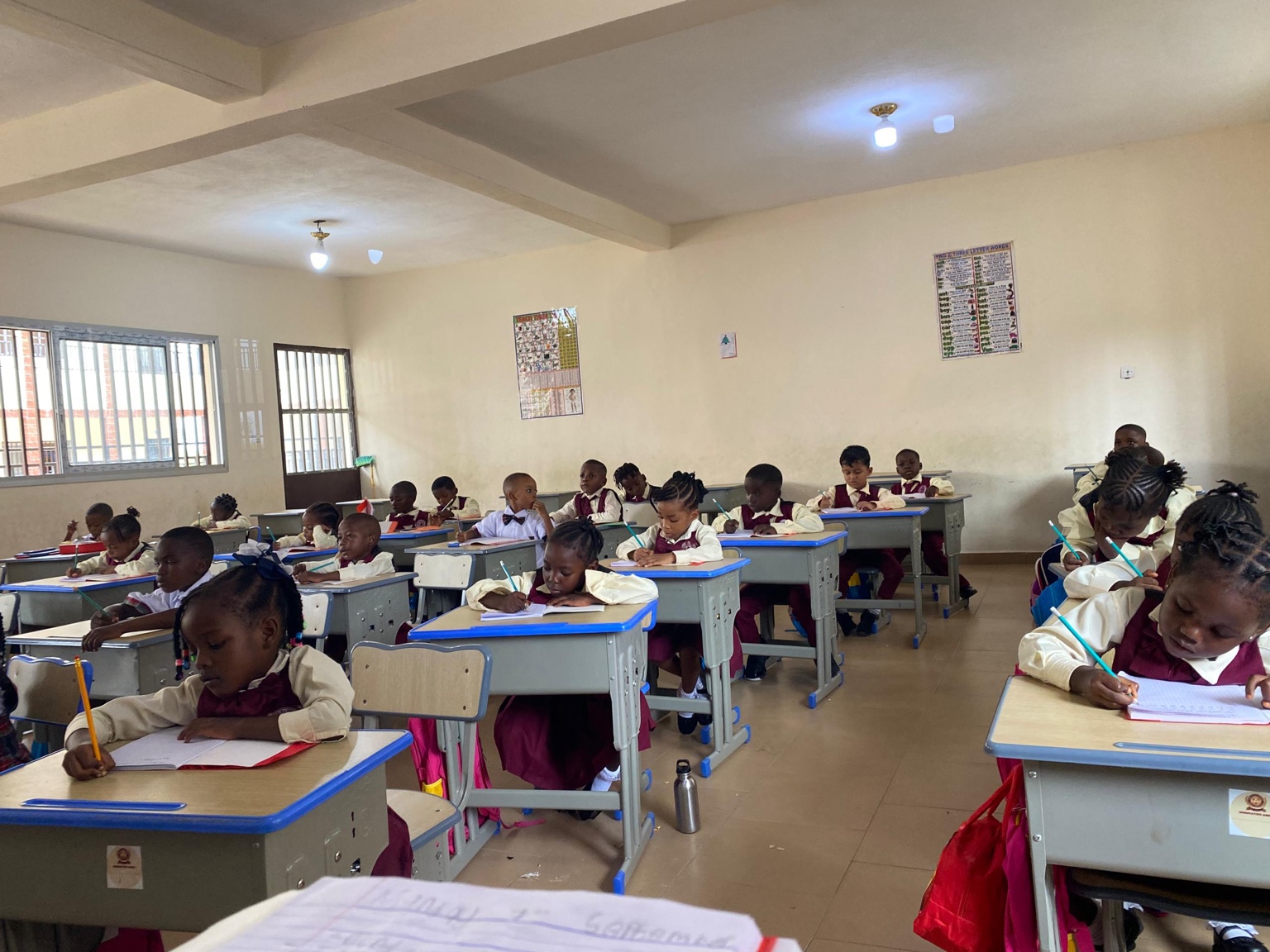 Younger pupils writing in their notebooks