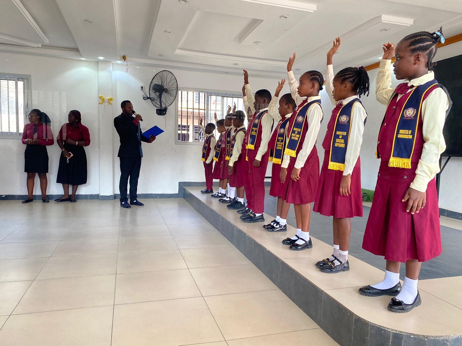 Pupil representatives raising their hands during the school ceremony